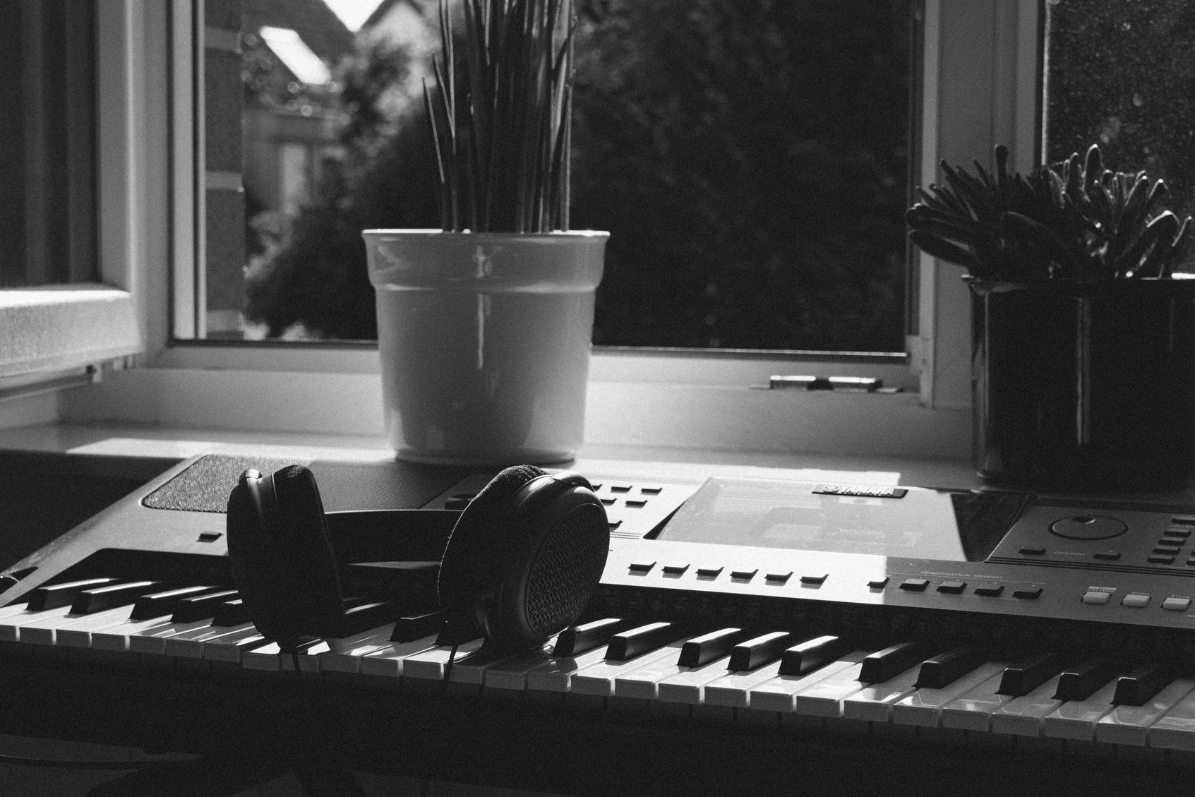 Grayscale Photography of Electronic Keyboard Near Window